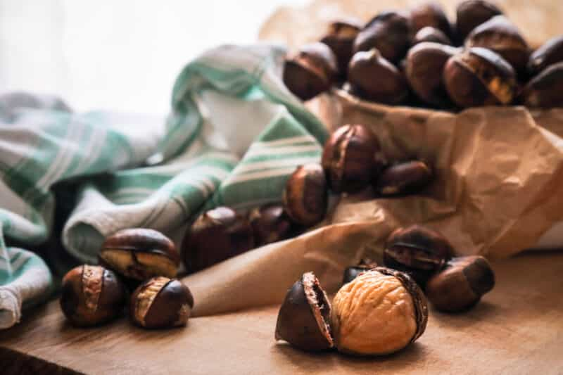 Fresh roasted chestnuts on wooden cutting board