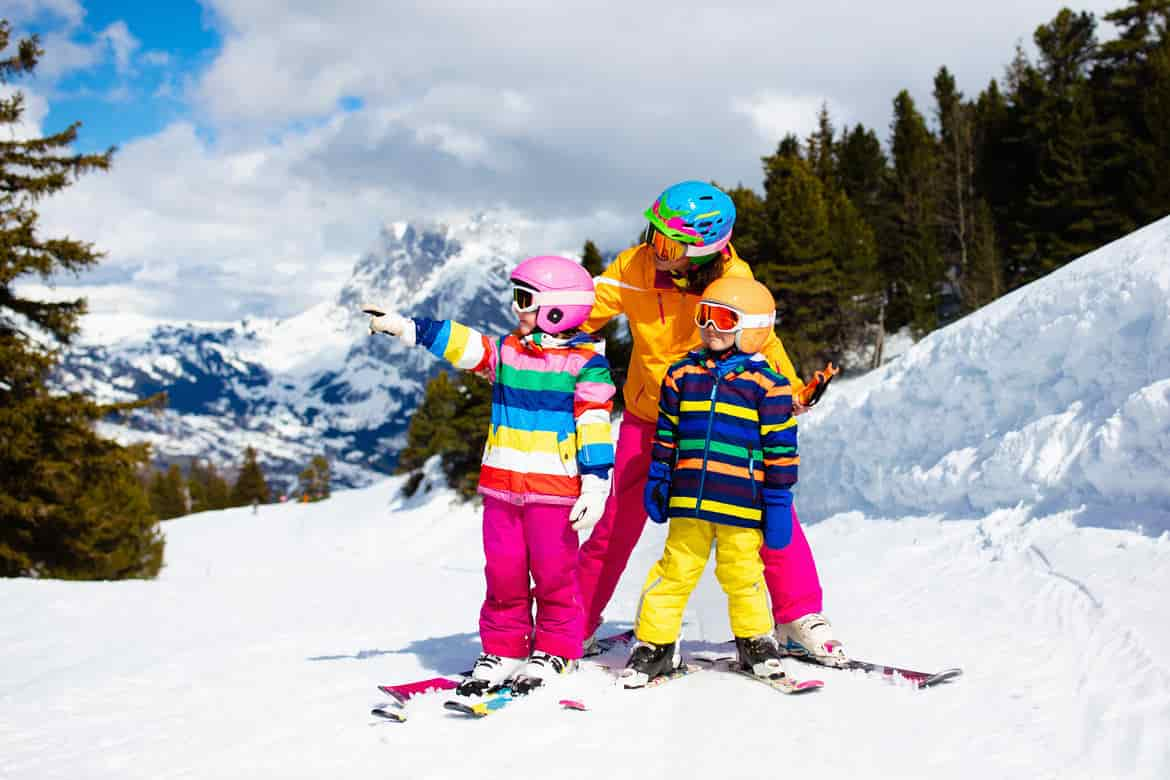 Family skiing in mountains. Mother and kid ski.